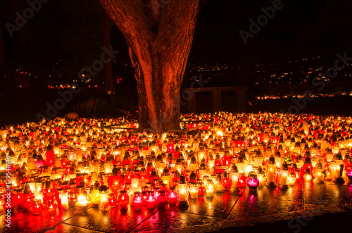 Fotografie Graveyard candles on Polish cemetery during All Saints Day at night