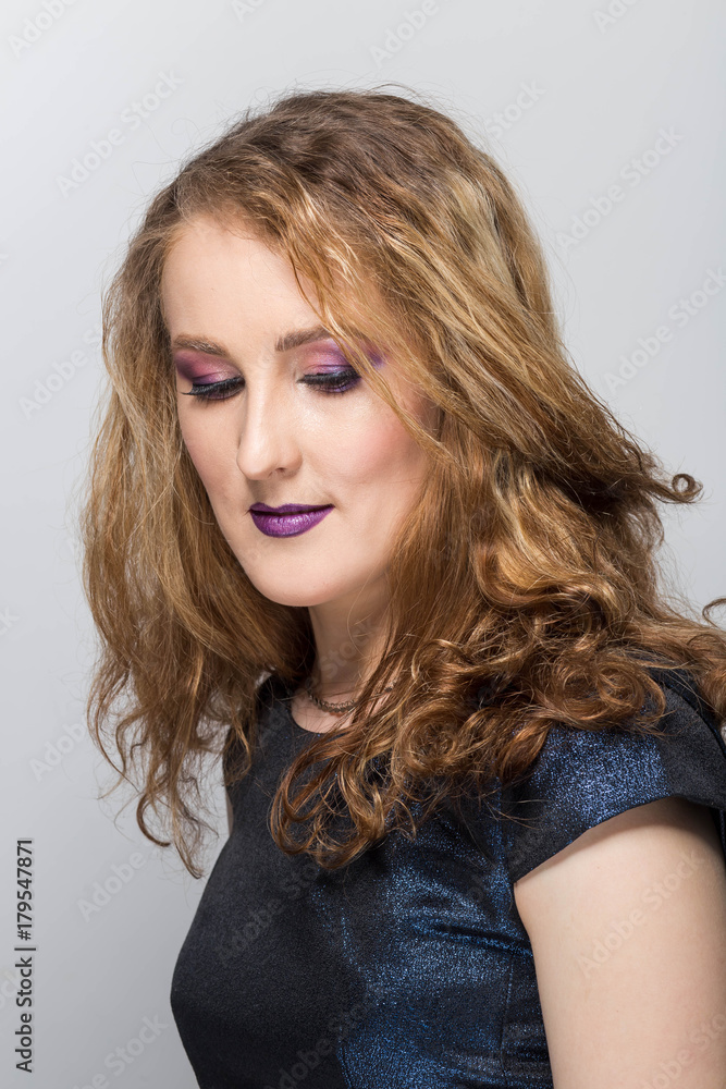 Young smiling woman portrait. Positive emotions. Look down, close-up Young smiling woman portrait. Positive emotions. Look down, close-up