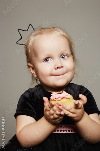 smiling child girl with sugar cake