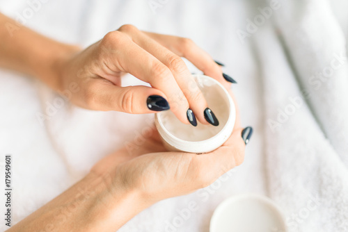 Female person hands with beauty product closeup