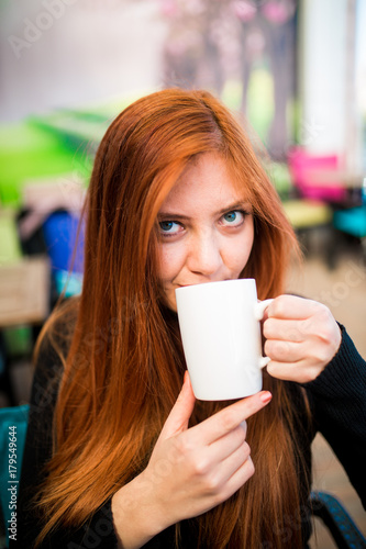 Beautiful girl drinking coffee at the coffee shop