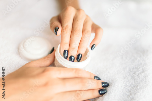 Female person hands with beauty product closeup