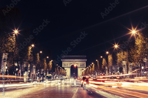 Photography Illuminated Arc de Triomphe and the avenue Champs-Elysees in Paris