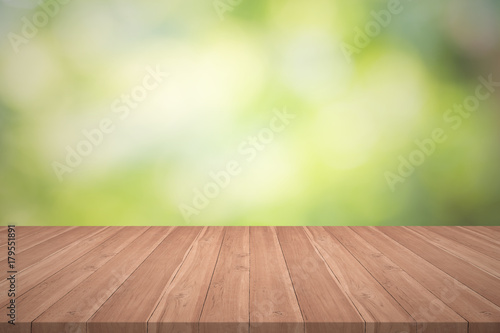 Wood table top on nature green blurred background for montage your products