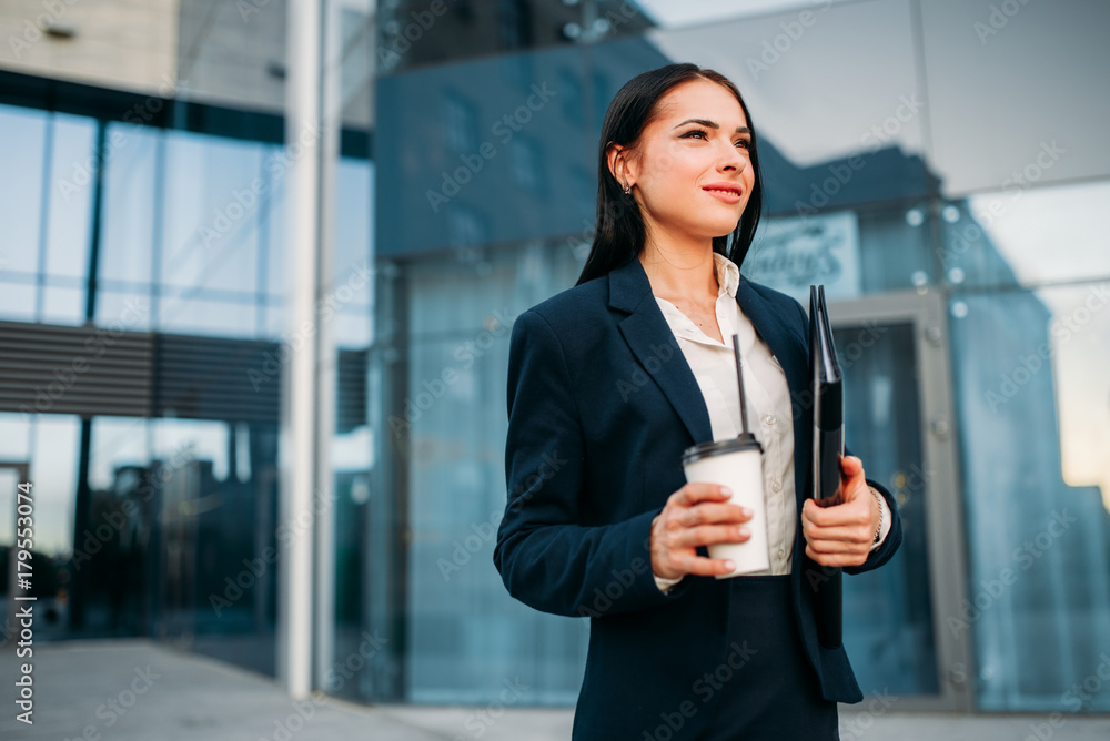 Business woman in glasses with coffee in hands Business woman in glasses with coffee in hands