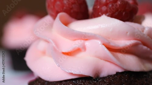 Wallpaper Mural chocolate kupchake with pink cream. decorated with three raspberry berries. Holiday cakes are on the table. Macro shooting of the cherry cheese cream. Shooting from the slider. hd Torontodigital.ca