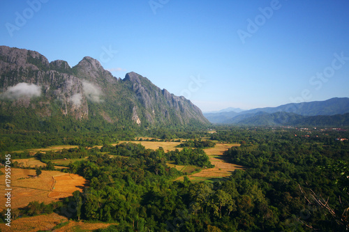 Beautiful mountains scenery in spring.View at a mountain range with morning fog in a mountain valley in Vang vieng, Laos