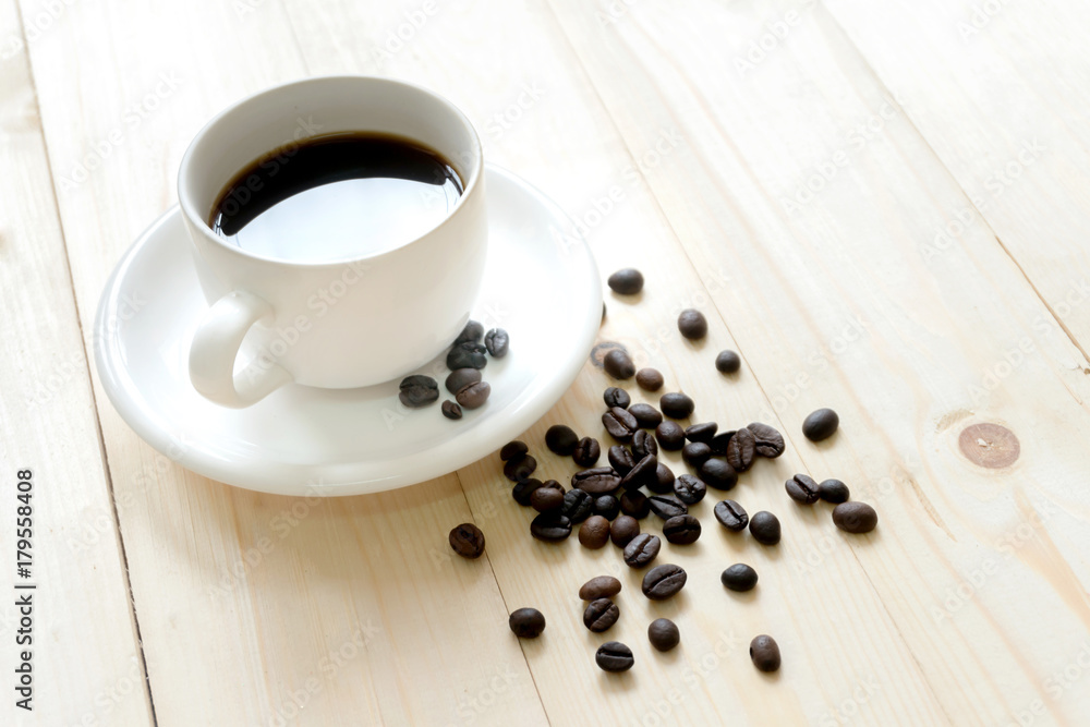 Coffee beans on wooden table with coffee mug. Coffee beans on wooden table with coffee mug.