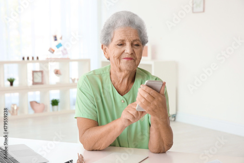 Elderly woman using cell ph...