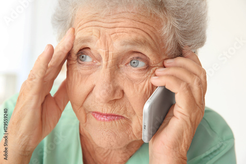 Elderly woman speaking on c...