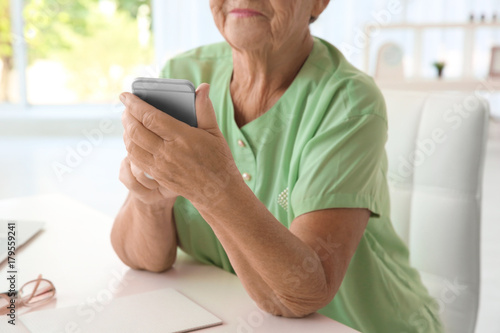 Elderly woman using cell ph...