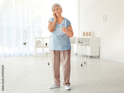 Elderly woman speaking on c...