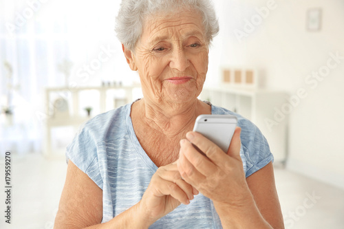 Elderly woman using cell ph...