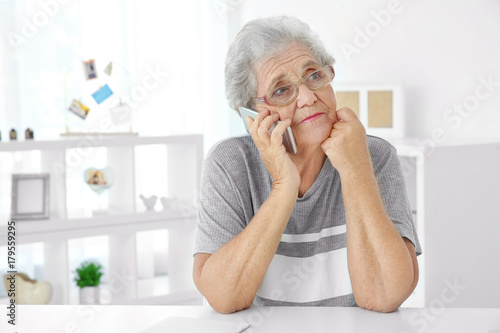 Elderly woman speaking on c...