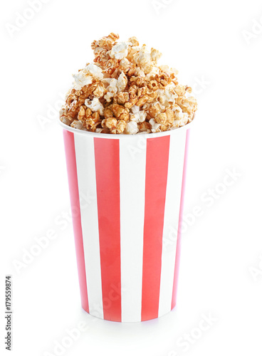 Cup with tasty caramel popcorn on white background