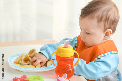 Cute little baby eating sli...