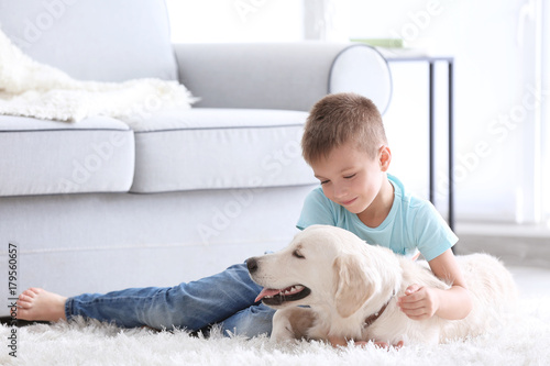 Cute little boy with dog at...
