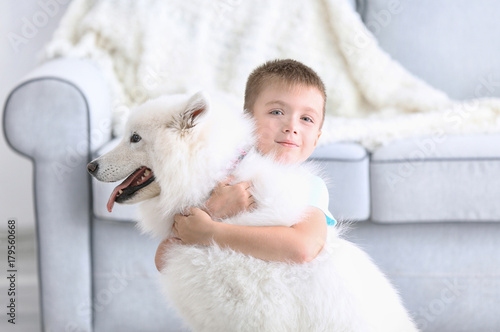 Cute little boy with dog at home