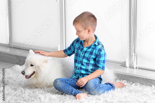 Cute little boy with dog at...