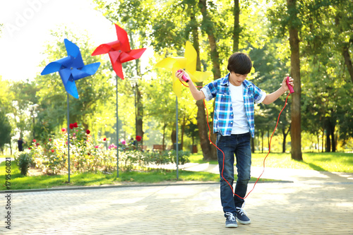 Cute little boy jumping rop...