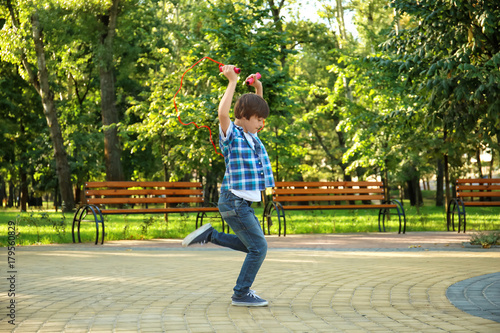 Cute little boy jumping rop...