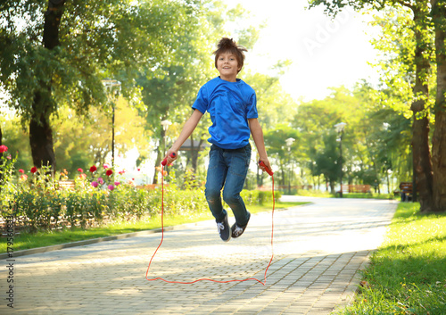 Cute little boy jumping rop...