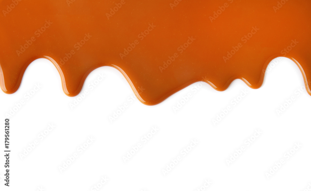 Flowing caramel sauce, isolated on white