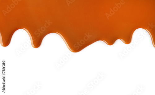 Flowing caramel sauce, isolated on white