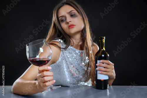 Young woman drinking alcoho...