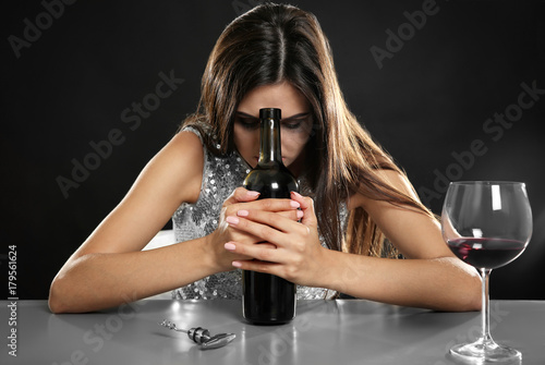 Young woman drinking alcoho...
