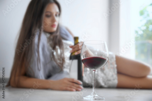 Young woman drinking alcoho...