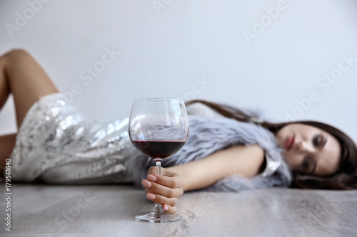 Young woman drinking alcoho...