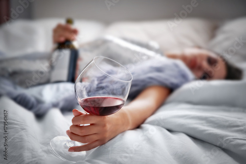 Young woman drinking alcoho...