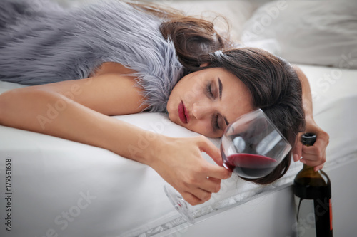 Young woman drinking alcoho...