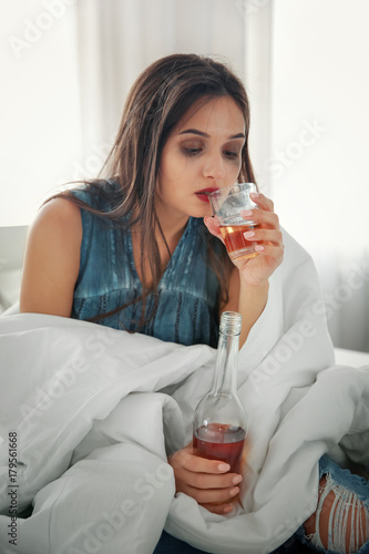 Young woman drinking alcoho...