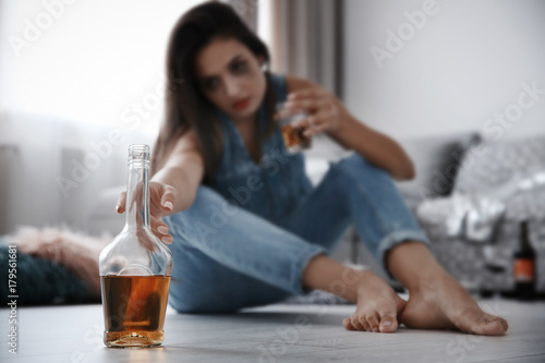 Bottle with alcohol and wom...