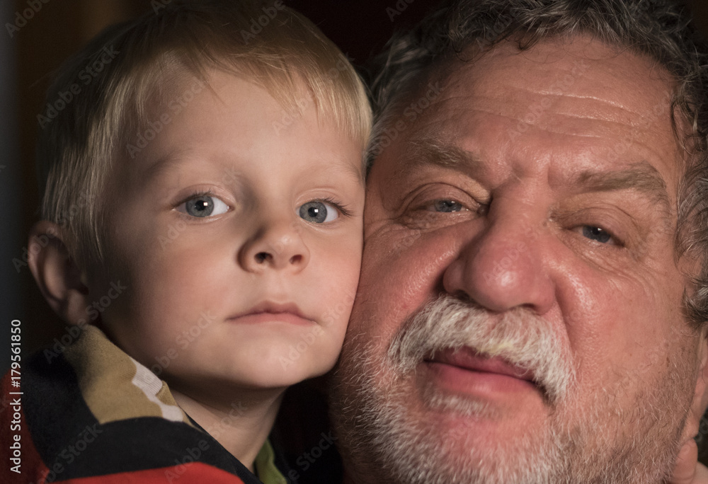 Caucasian grandfather with grandson looking at camera Caucasian grandfather with grandson looking at camera