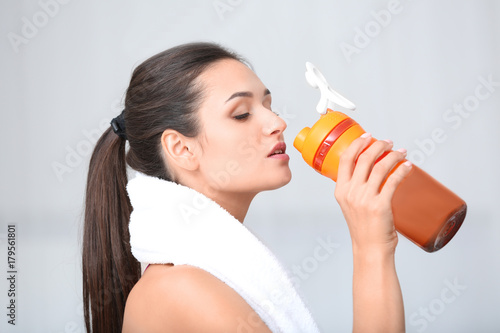 Young woman drinking protei...
