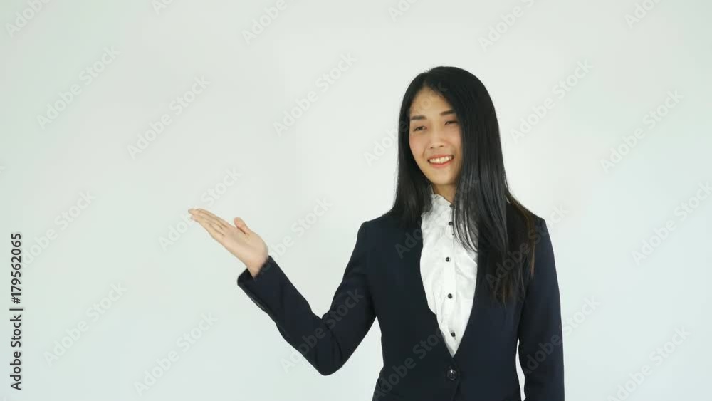 Closeup of young business woman with presenting something on her hand smiling at camera and showing at blank copy space Closeup of young business woman with presenting something on her hand smiling at camera and showing at blank copy space