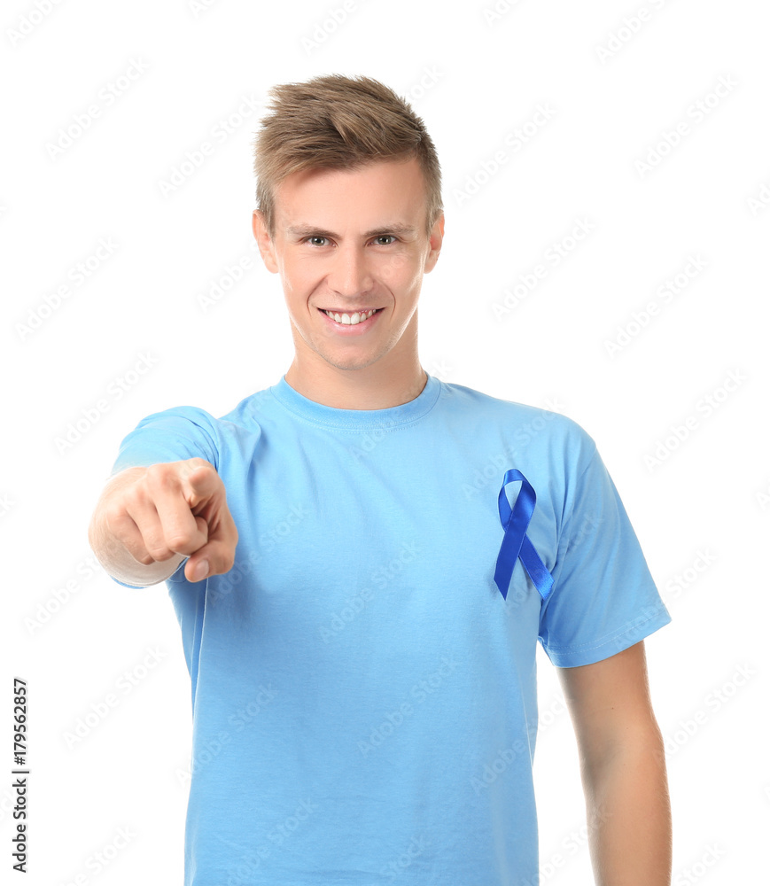 Fototapeta premium Young man wearing t-shirt with blue ribbon on white background. Prostate cancer awareness concept