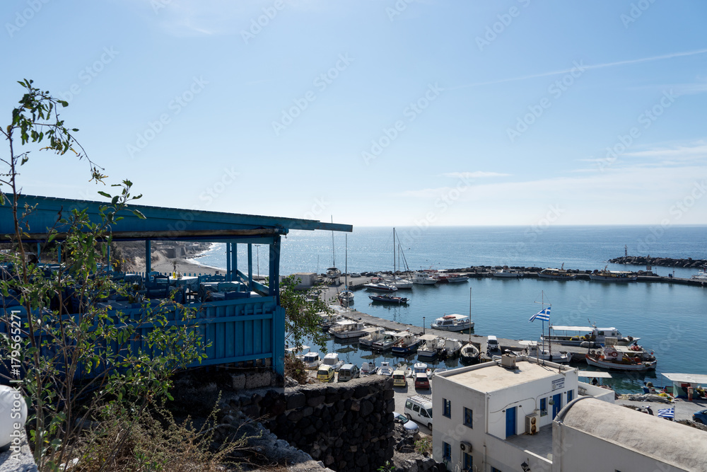 View on port of Vlichada town full with small fishing boats at Santorini island