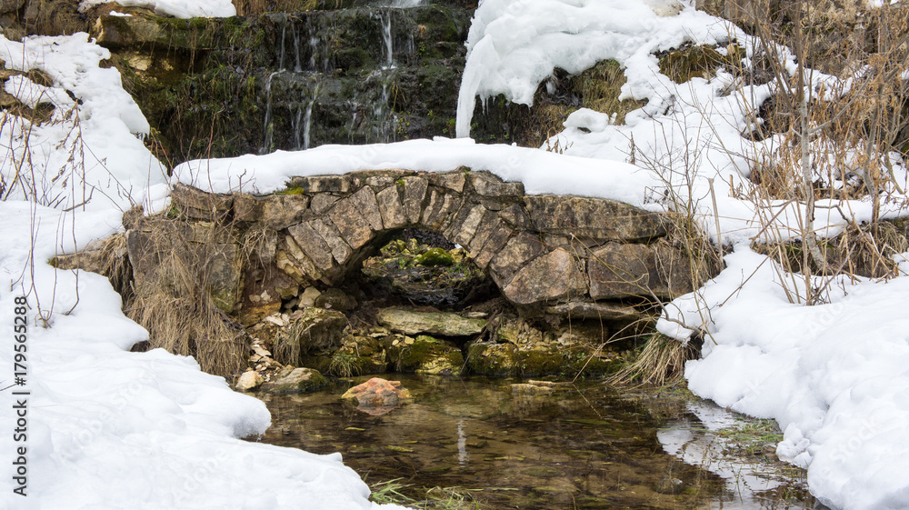 Waterfall and bridge in place of an abandoned quarry, where limestone was previously mined. Waterfall and bridge in place of an abandoned quarry, where limestone was previously mined.