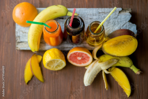 Delicious array of fresh fruit juices served in tall glasses made from liquidised orange, kiwifruit with peppermint, and strawberries for healthy summer treats rich in vitamins