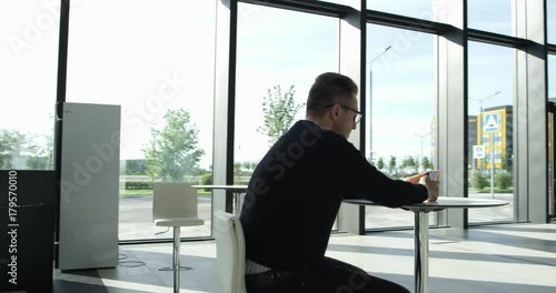 Man using smartrphone in cafe photo