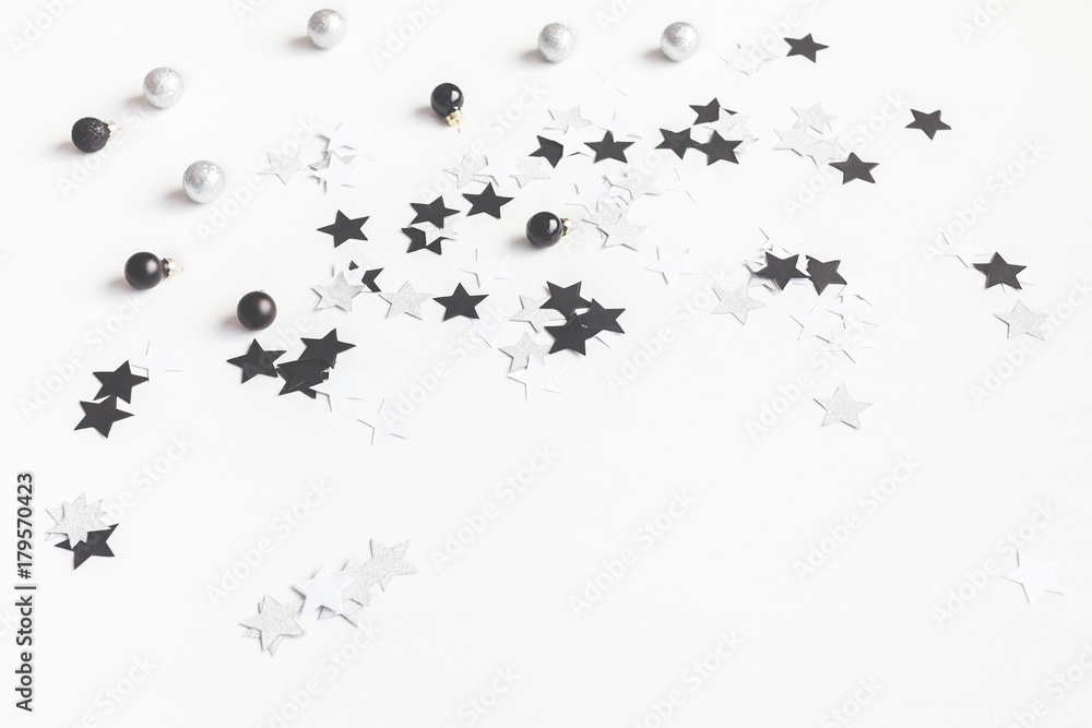 Obraz premium Christmas composition. Christmas balls and paper confetti on white background. Front view, copy space
