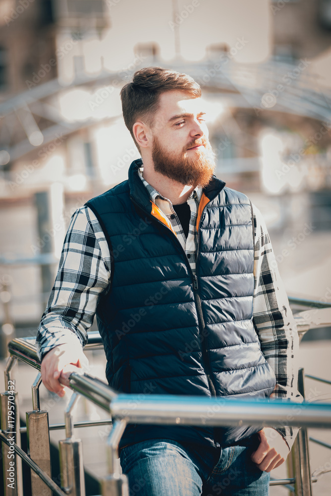 Handsome bearded man in casual clothes posing on camera Handsome bearded man in casual clothes posing on camera