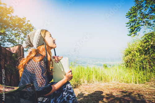 Wallpaper Mural Asian women travel relax in the holiday. camping on the Mountain. sit read a book on the chair. Thailand Torontodigital.ca