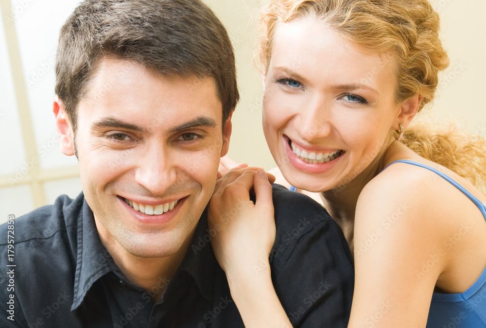 Cheerful smiling young couple, indoors Cheerful smiling young couple, indoors
