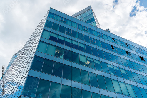 Glass office building on sky background