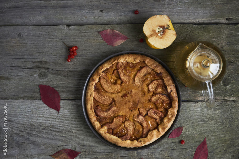 Homemade apple quince pie with fresh fruits on rustic wooden background. Top view